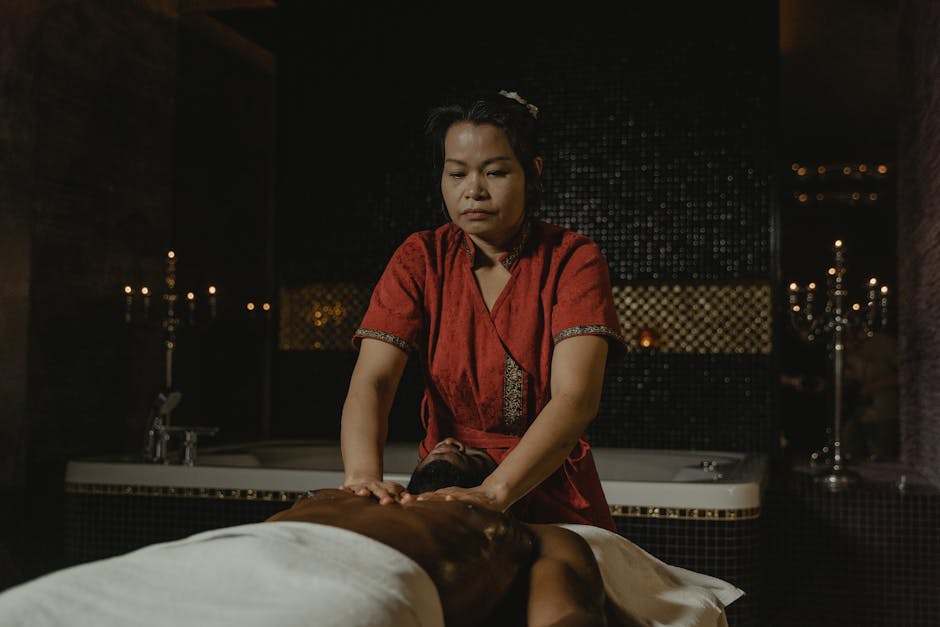 A skilled masseuse provides a relaxing massage in a tranquil spa setting, enhancing relaxation and wellness